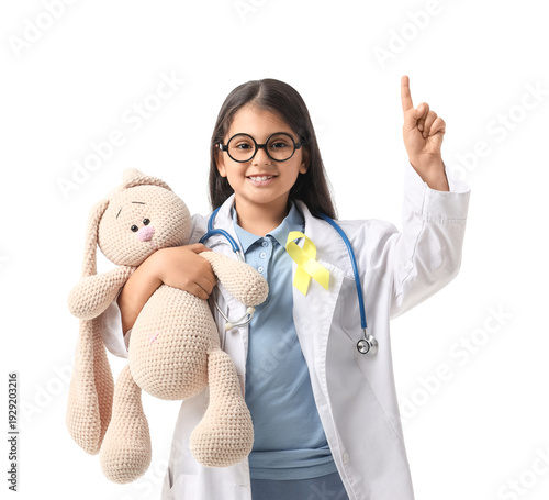 Cute doctor with toy and ye...