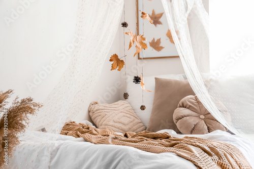 Comfortable bed with autumn...