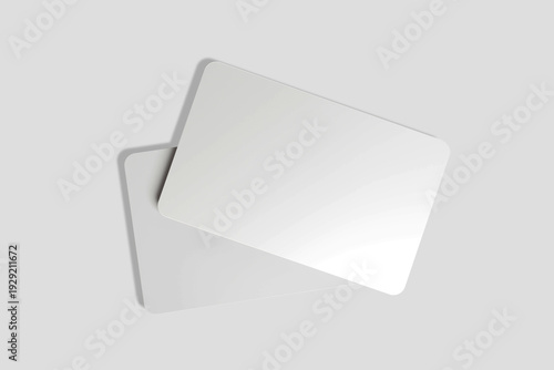 A close-up of two white, rectangular cards with rounded corners, overlapping on a light gray background