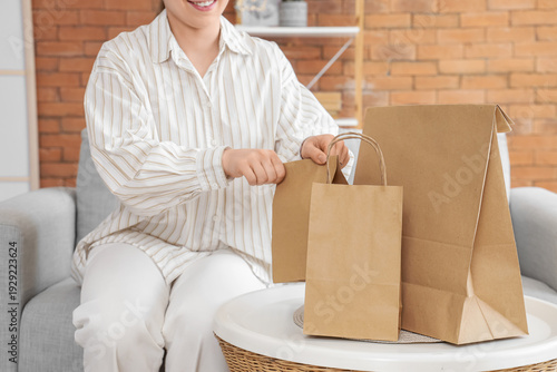 Young woman putting paper b...