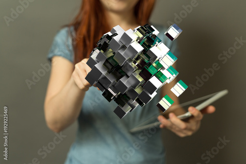 A woman holds a tablet, int...