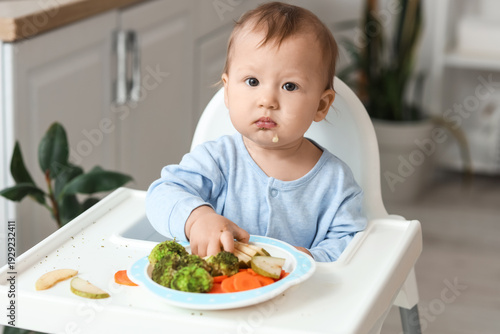 Cute little baby eating fre...