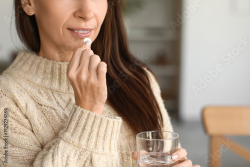 Beautiful woman taking medi...