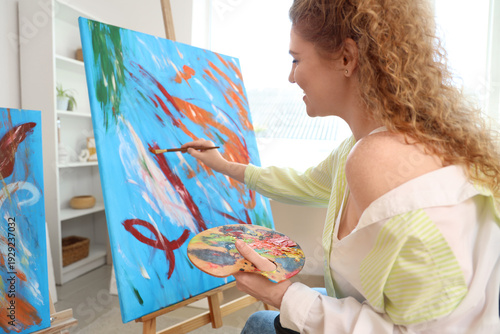 Female artist painting on c...