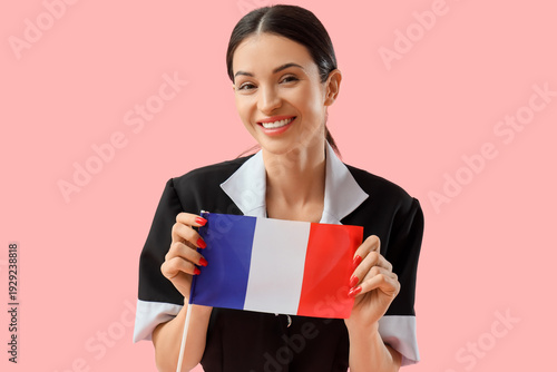 Young chambermaid with flag...