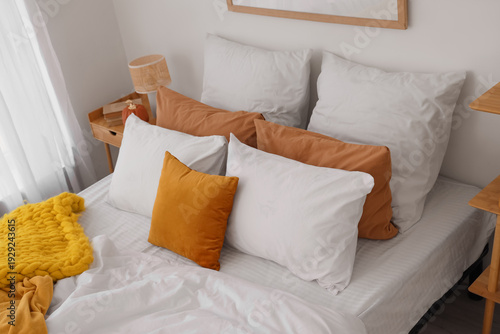 Cozy bed with soft pillows ...