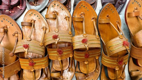 Authentic Kolhapuri chappals displayed in vibrant rows, showcasing handcrafted Indian leather footwear with intricate detailing and traditional artisan craftsmanship at a local market.