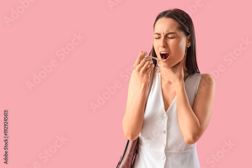 Young woman with syrup for ...