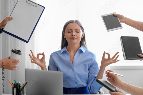 Meditating businesswoman an...