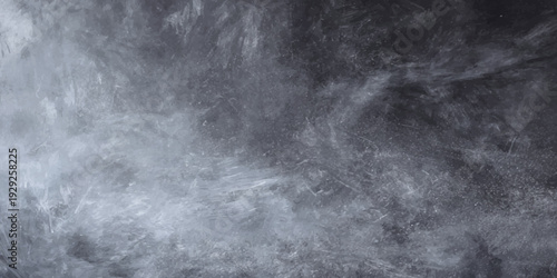 A dramatic black and white image capturing the motion of water flowing amidst dark misty clouds and stormy night weather