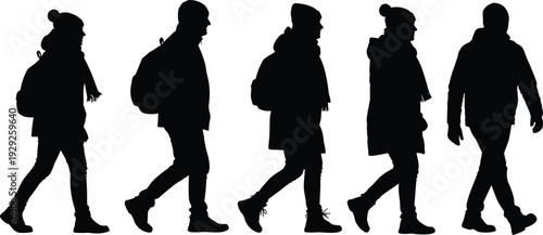 Collection of black silhouettes of people walking in winter clothes, travelers with backpacks, pedestrians in warm jackets and hats set.