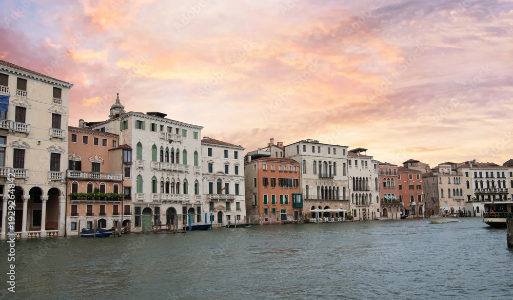 Obraz premium Venice palazzos on Grand Canal with motorboat at sunset