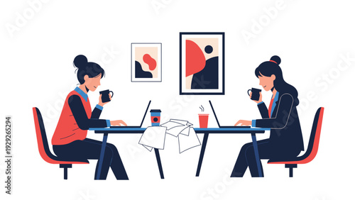 Businesswomen working on laptops and drinking coffee while sitting at a shared office table with abstract paintings on the wall.