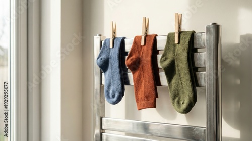 Pairs of socks hanging on a chrome drying rack