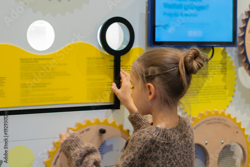 Fotografia Child interacting with an educational exhibit in an interactive museum, examinin