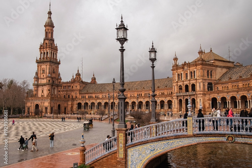 Plaza de Espana, Sivilla. Historic stone building with towers and courtyard under cloudy sky