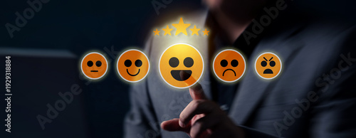 A hand selects a positive emoji on a touchscreen interface, triggering a five star customer rating within an interactive digital review system.