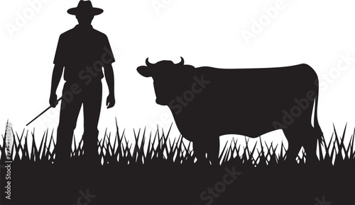 Black silhouette of cowboy with cattle in grass bull