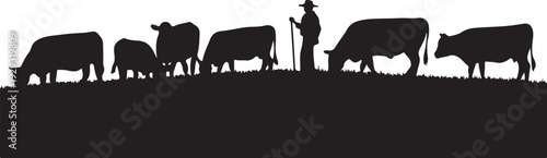 Black silhouette of cowboy with herd of cows grazing on hill