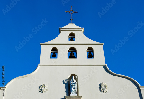 Bell tower of XVIII century Spanish-style Cathedral Basilica of St. Augustine against clear blue sky in St. Augustine, Florida, USA