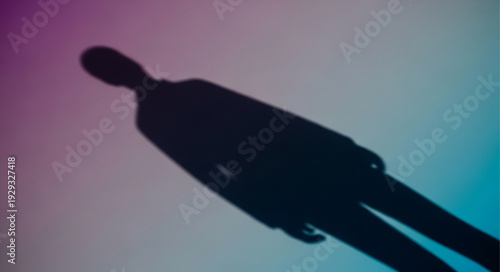 Silhouette of a person against a colorful gradient background.