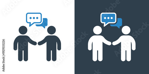 Two people talking to each other shaking hands in conversation