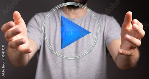 Person holding a play butto...