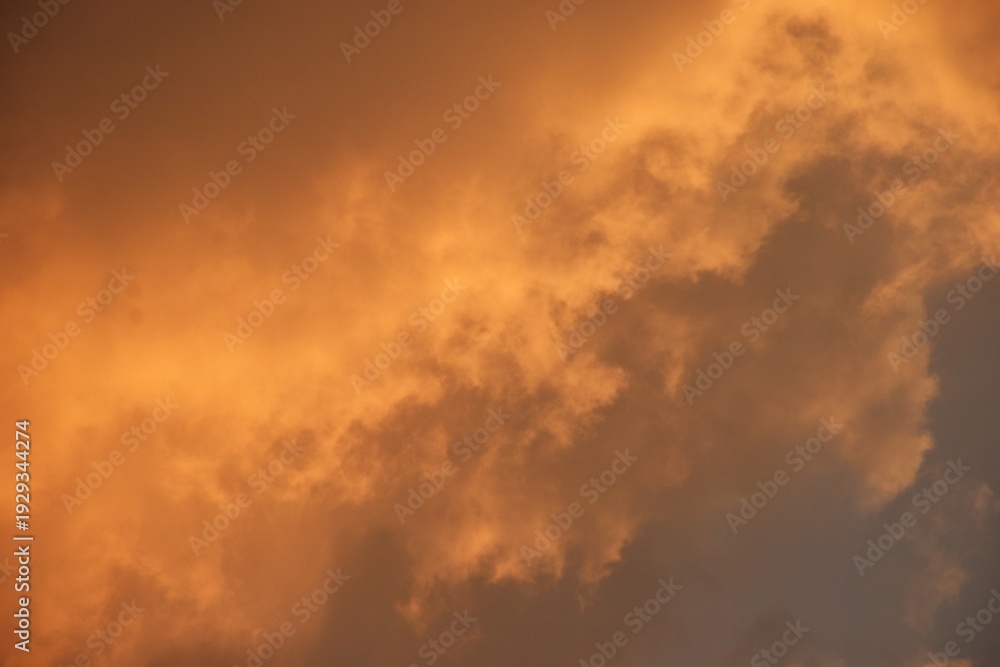 Fototapeta premium white and orange cloud spreading on twilight sunset blue sky in evening