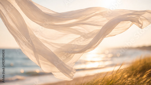 flowing fabric in summer breeze over seaside at sunset