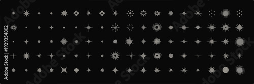 Collection of small glowing star shapes and sparkling light effects on dark background