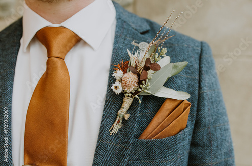 Photos Close up of mans suit, a groom on his wedding day with buttonhole