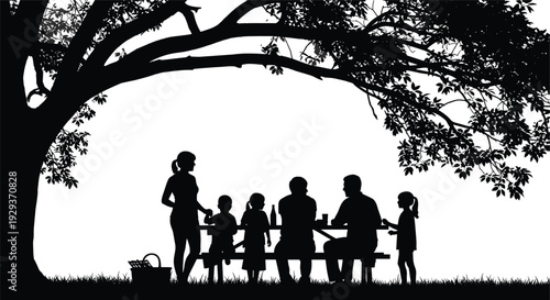 Silhouette of a happy multi generational family having a summer picnic at a table under a large shade tree outdoors.