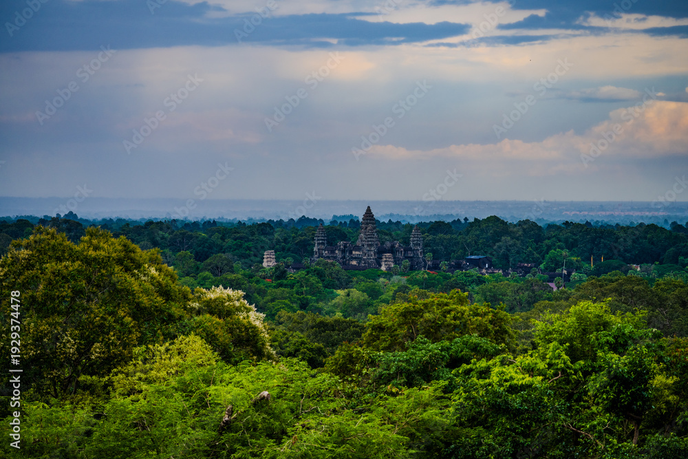 Fototapeta premium Ancient Angkor Wat temple rising above lush Cambodian jungle