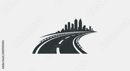 Curved road leading to a city skyline silhouette.