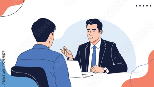 Two men in suits have a business meeting or job interview across a desk while one explains something with hand gestures.