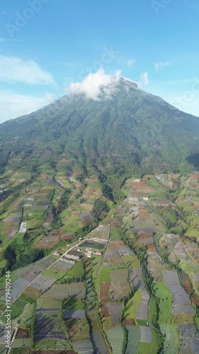 Aerial View of Mountain Terraced Farmland and Reservoir Near Village on a Clear Sunny Day