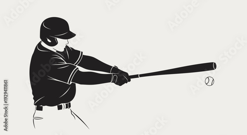 Focused male baseball player in a cap and uniform hitting a baseball with a bat in bright studio.