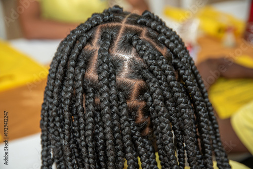 Professional hairstyle with box braids: close-up of the scalp, patterns and sections, precise square sections on the scalp. Afro texture.