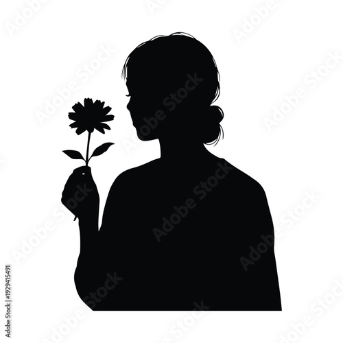 Silhouette of woman holding flower with elegant hair