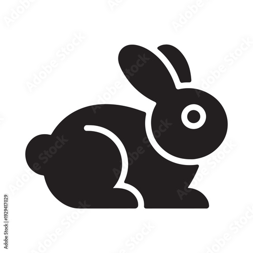 A simple black silhouette of a rabbit in a crouching position
