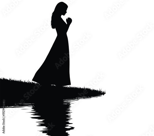 Serene woman standing by water with contemplative expression