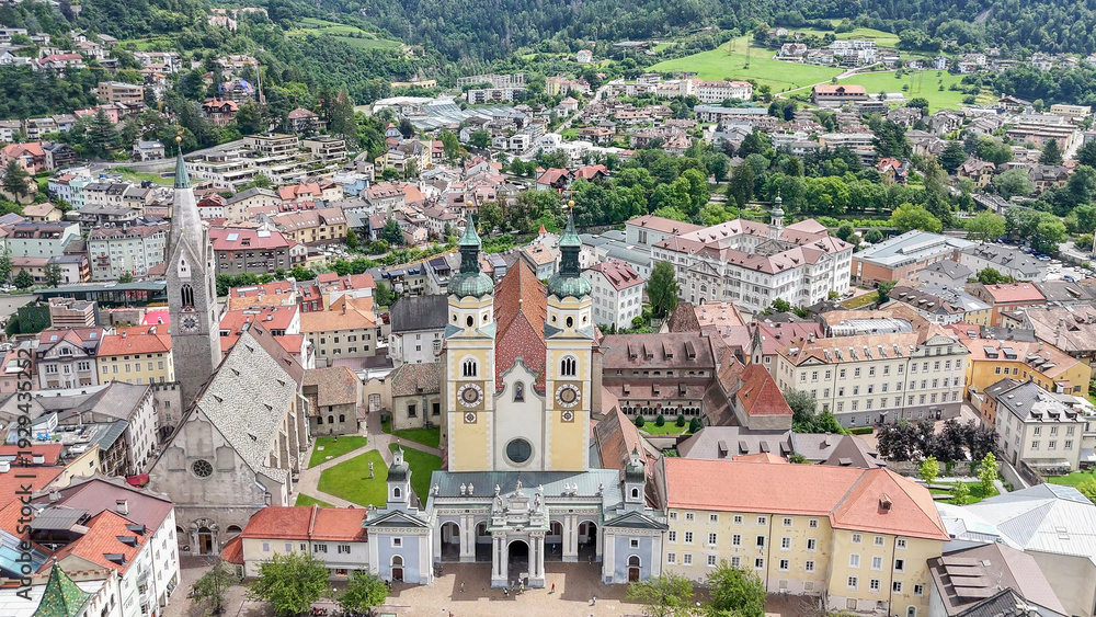 Fototapeta premium aerial drone view, Brixen, Bressanone city. View on the grand place with the cathedral and St. Michael church. sunny summer view. Photo for tourist brochure, publicity. City in south Tyrol.