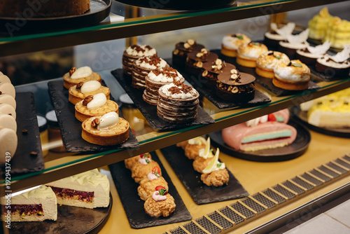 Assorted gourmet pastries and desserts displayed in a glass bakery case at a patisserie