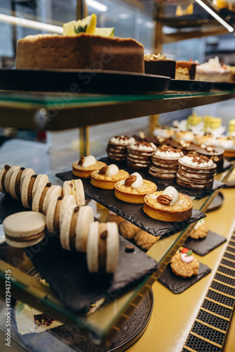 Assorted pastries and desserts displayed in a glass bakery case at a patisserie counter