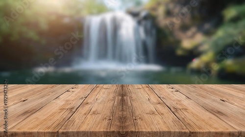 Empty wooden table top with blurred waterfall in tropical forest background