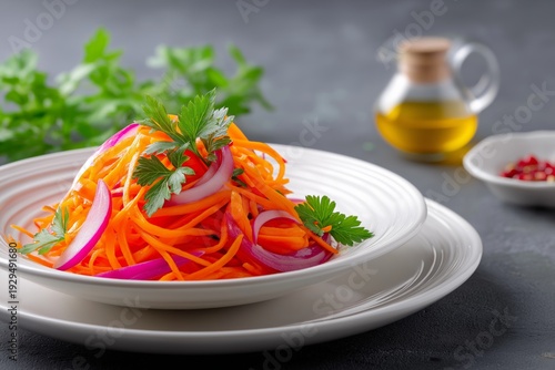 Traditional Korean-style spicy carrot salad on white plate, bright colors, ethnic cuisine concept