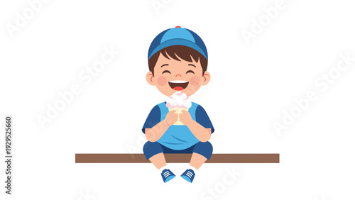 Happy young boy wearing a blue cap sitting on a bench and enjoying a delicious ice cream cone with a huge smile.