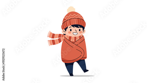 Cheerful young boy wrapped in a warm orange blanket and wearing a matching hat and scarf during the cold winter season.