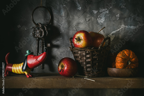 Apples and a small pumpkin on a shelf in the pantry