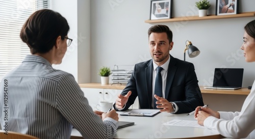 Professional meeting between colleagues discussing business strategies around a conference table.